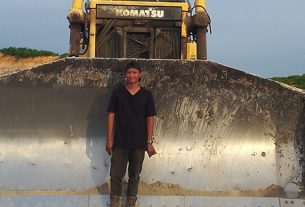 Yogi Novrian di depan Dozer yang dioperasikan selama bekerja di PT. MAS. (foto: Exclusive)